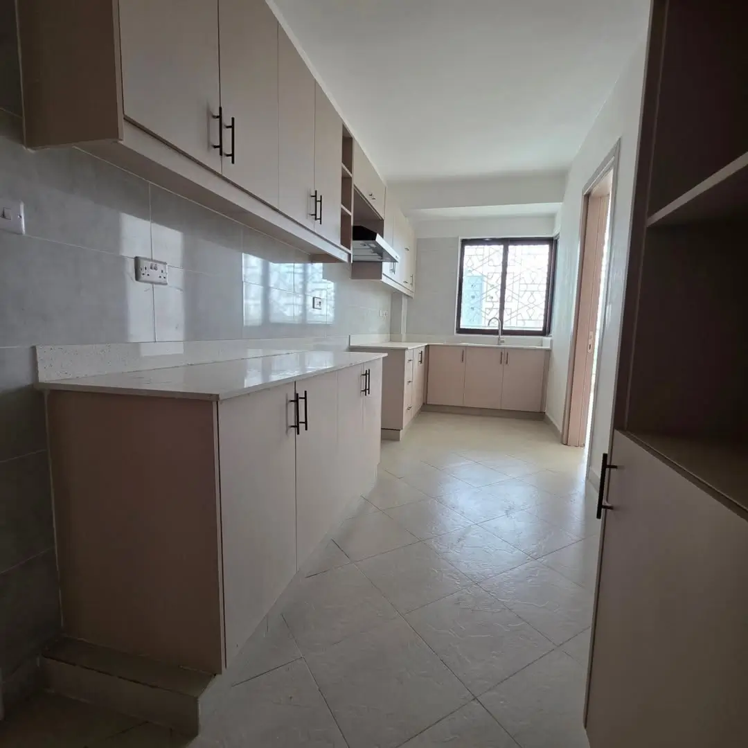Modern kitchen with white cabinets and glossy backsplash