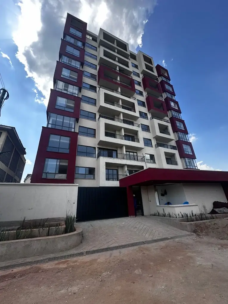 Modern multi-story residential building with red and white facade