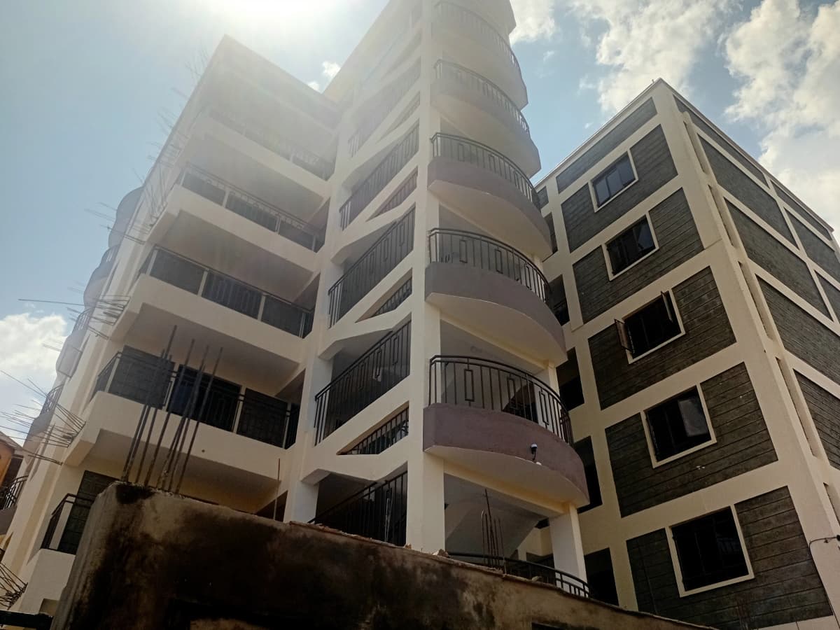 Multi-story residential building facade with curved balconies