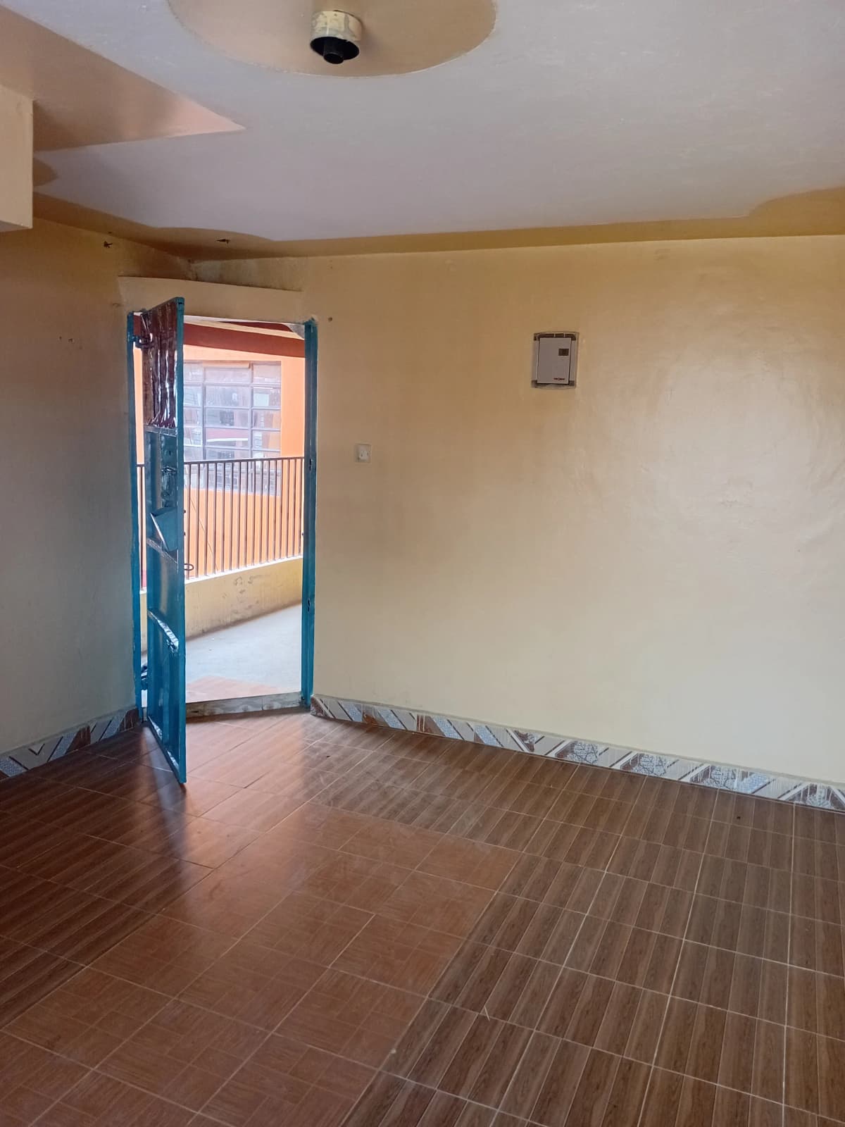 Spacious bedroom with direct balcony access and wooden flooring