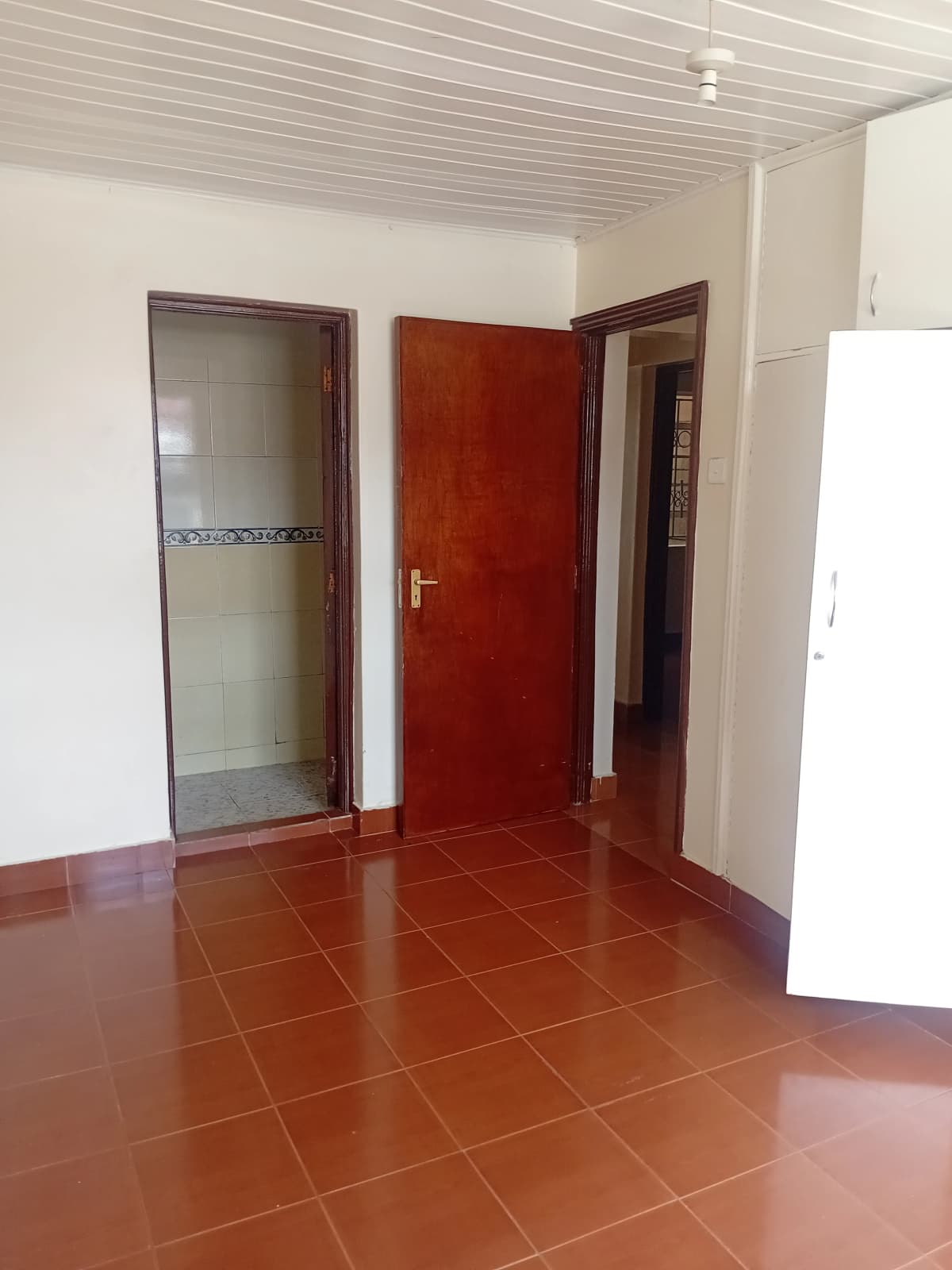 Bedroom with en-suite bathroom and terracotta tile flooring