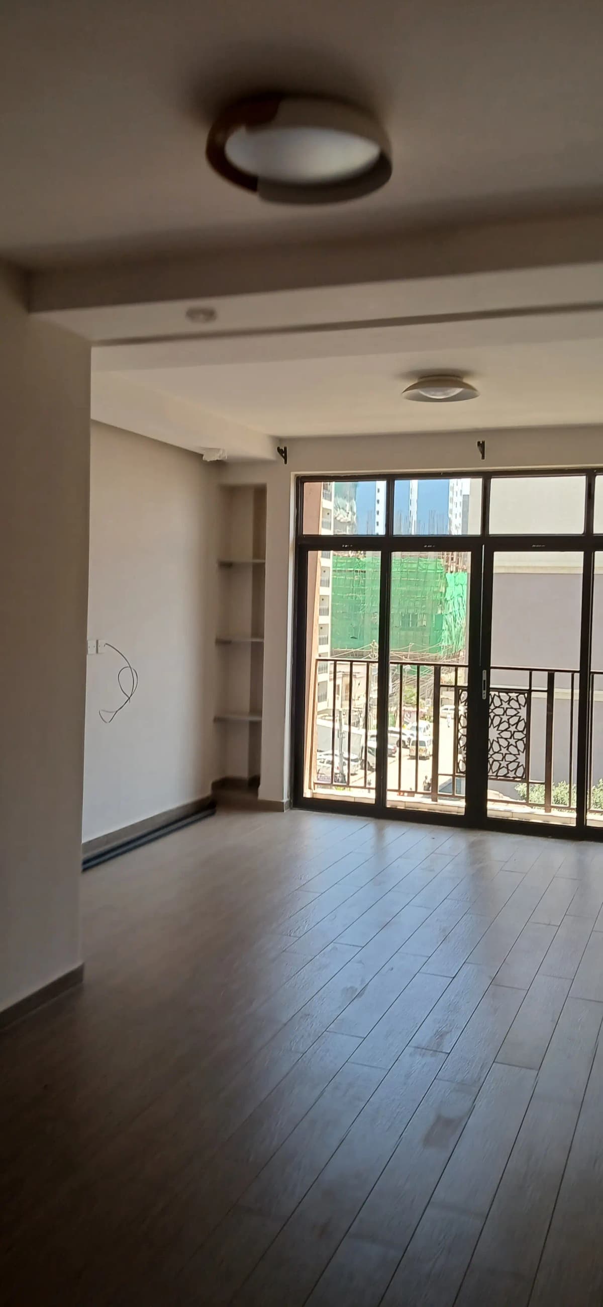 Bright living room with glass doors opening to balcony