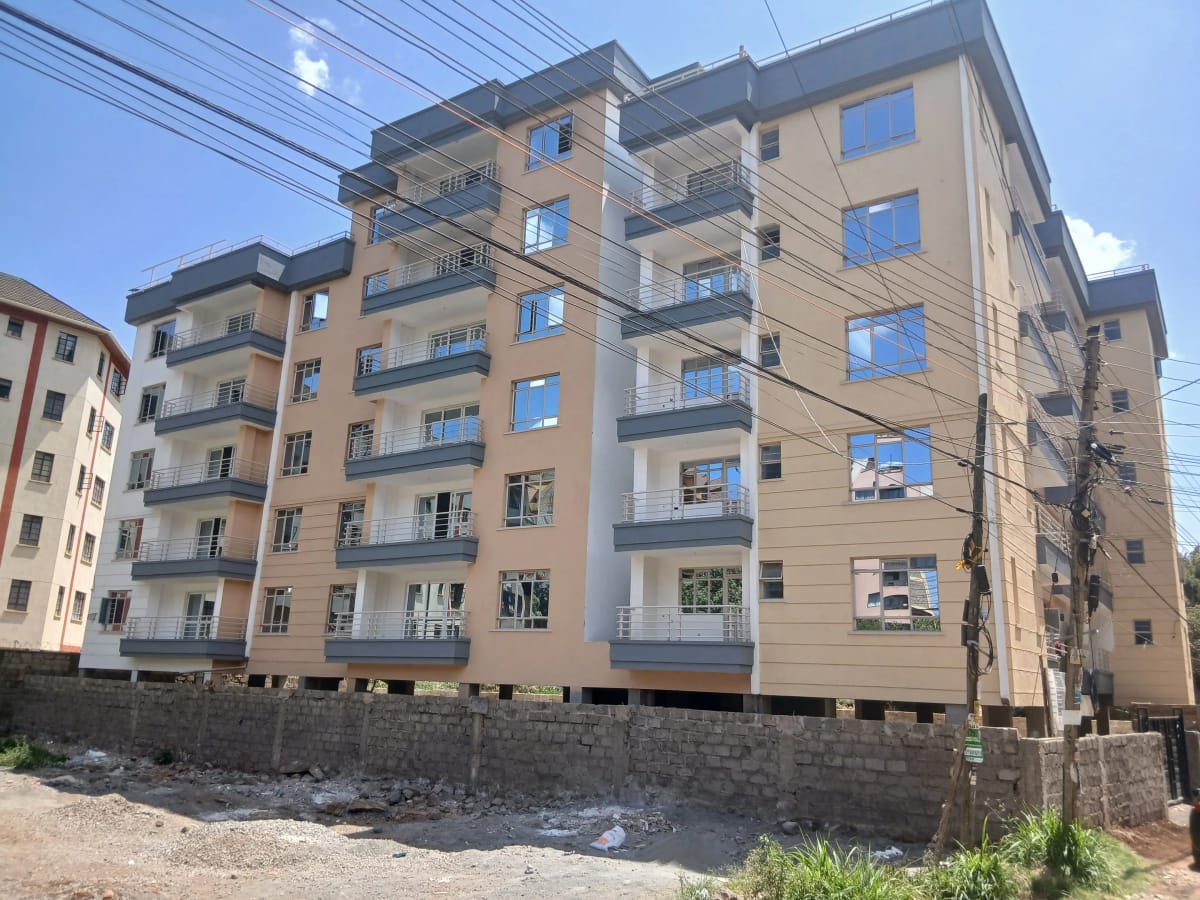 Multi-story residential apartment building with balconies and stone foundation