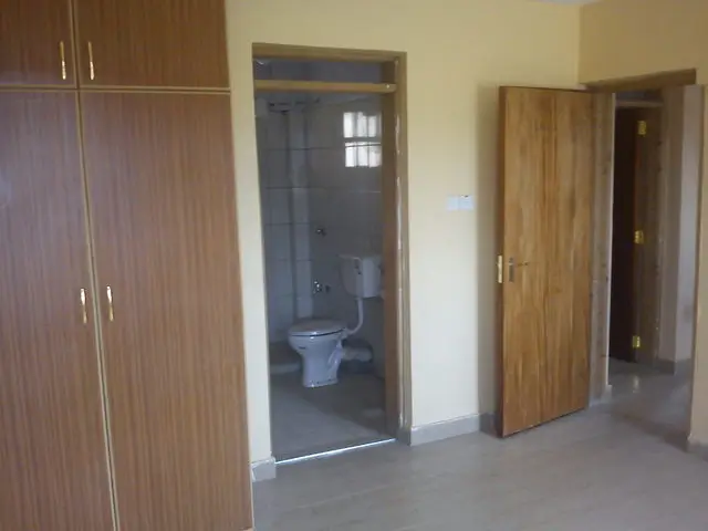 Compact bathroom with toilet and shower enclosure visible