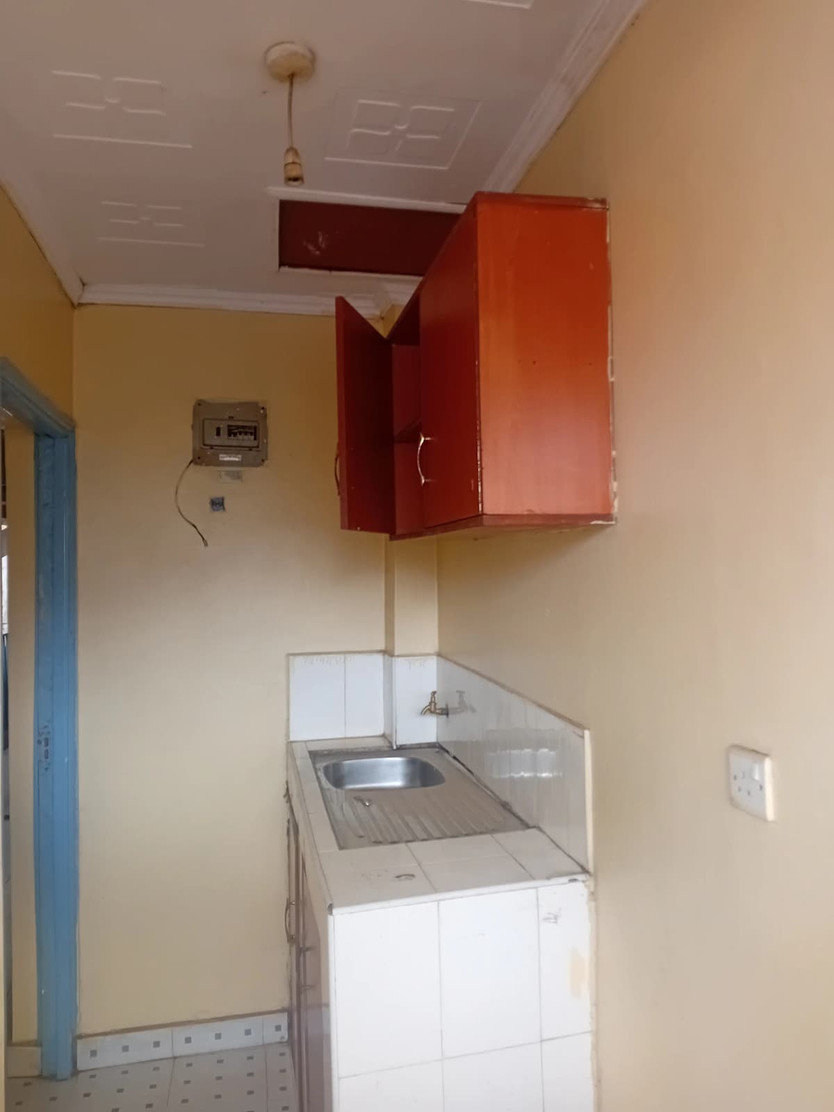 Compact kitchen with sink and upper storage cabinets