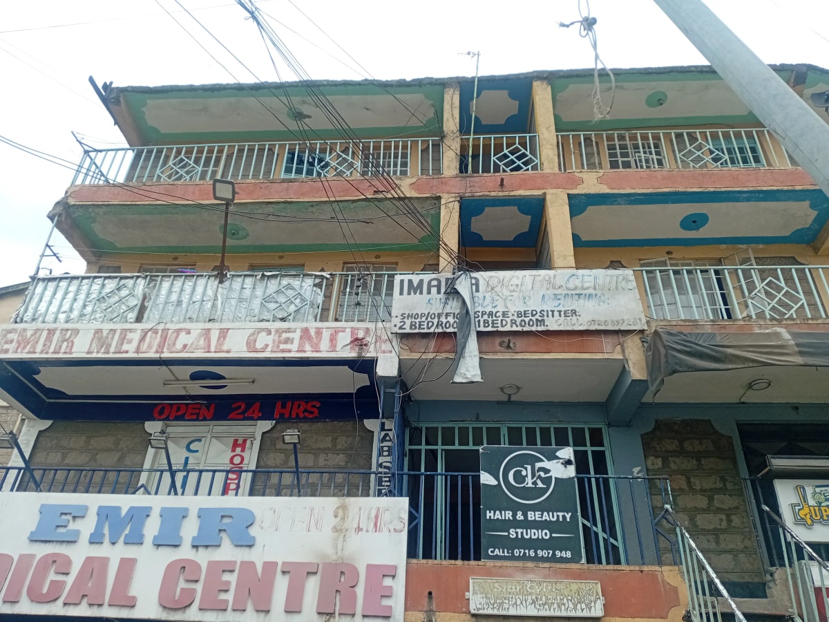 Multi-story residential building facade with commercial ground floor