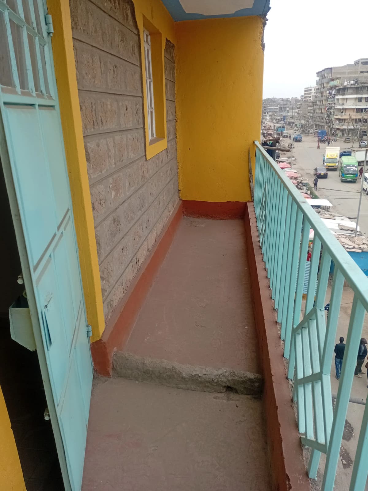 Narrow balcony with colorful painted walls and city views