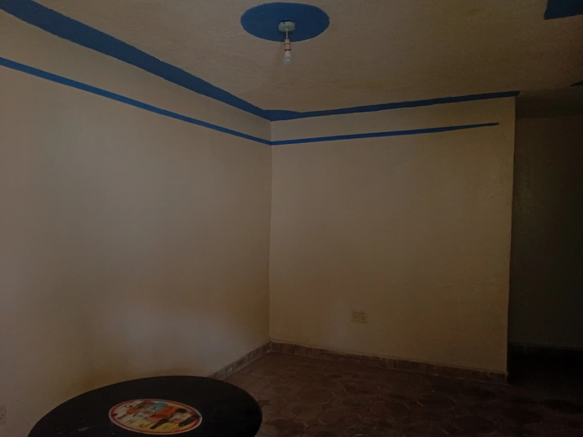 Empty bedroom with blue trim and ceiling fixture