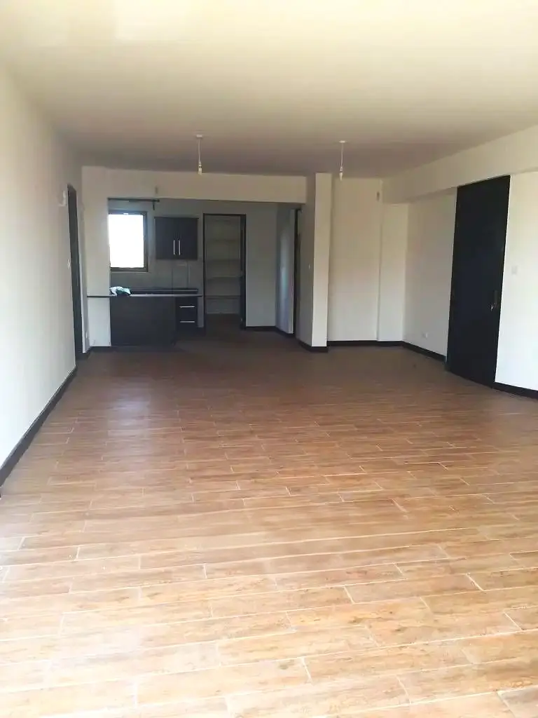Open-plan living area with integrated kitchen, wooden flooring
