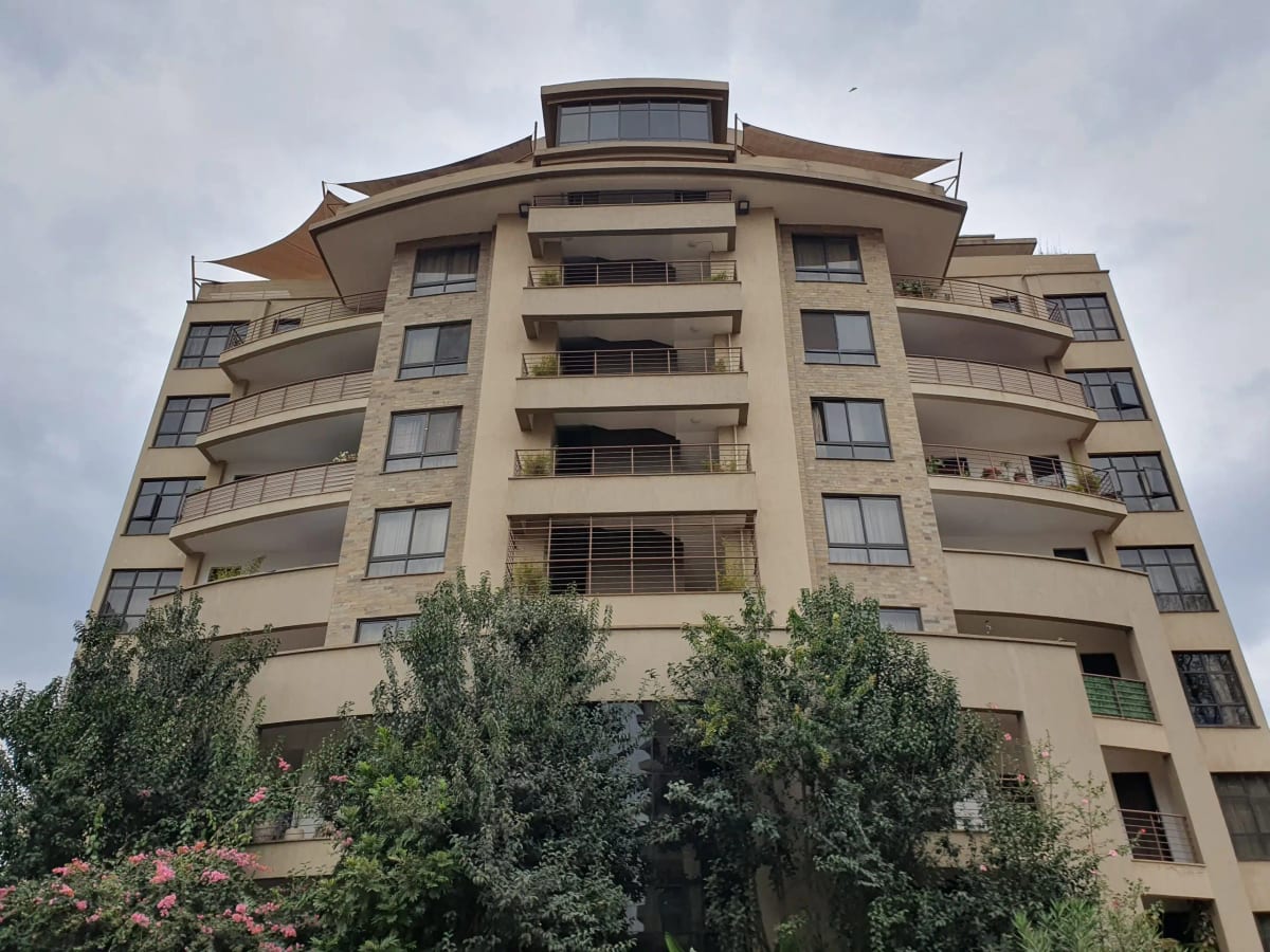 Multi-story residential building facade with curved balconies