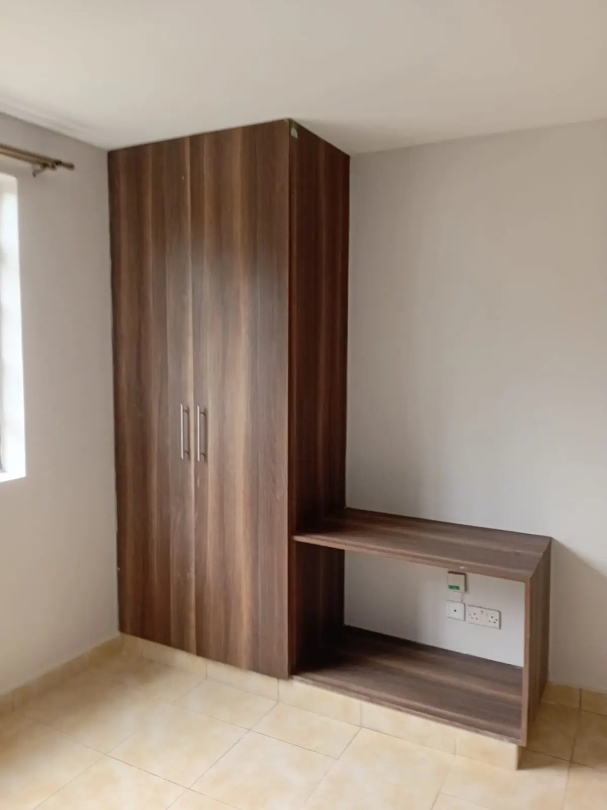 Bedroom with built-in wooden wardrobe and storage desk