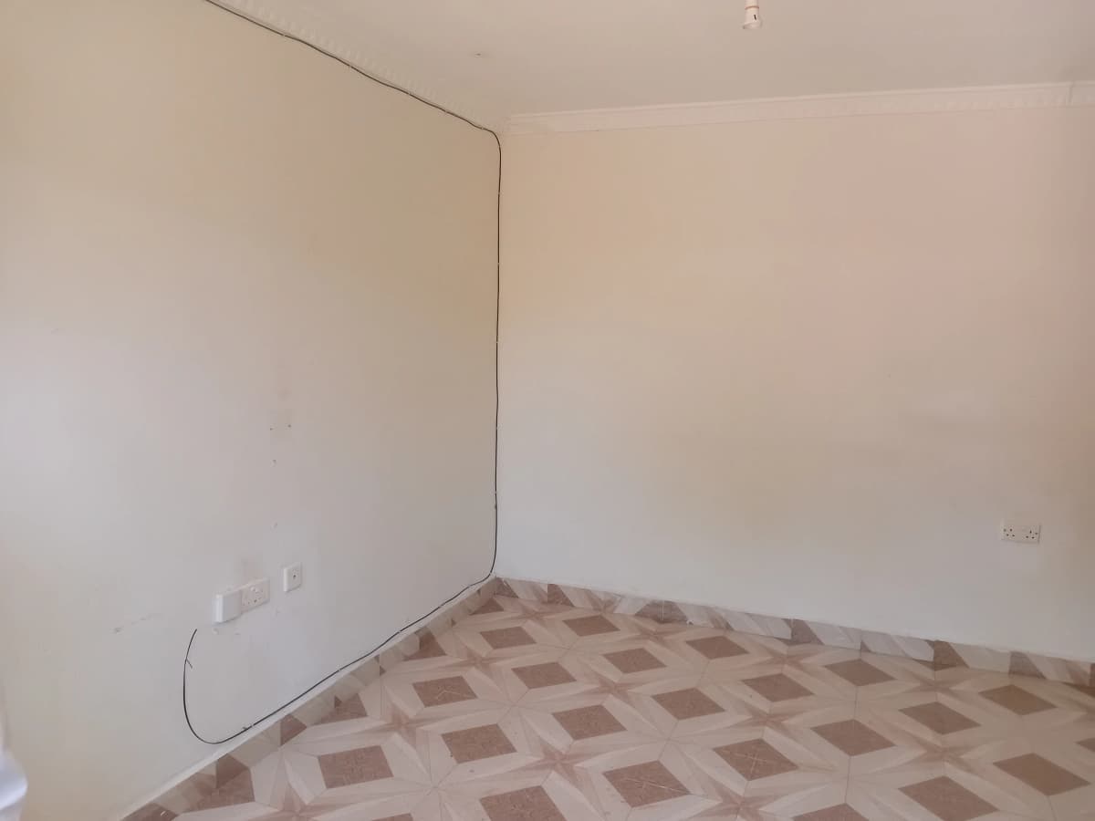 Empty bedroom with geometric tile flooring and bare walls