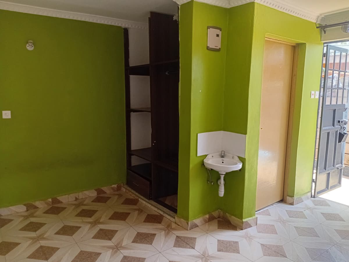Building lobby with bright green walls and shared sink