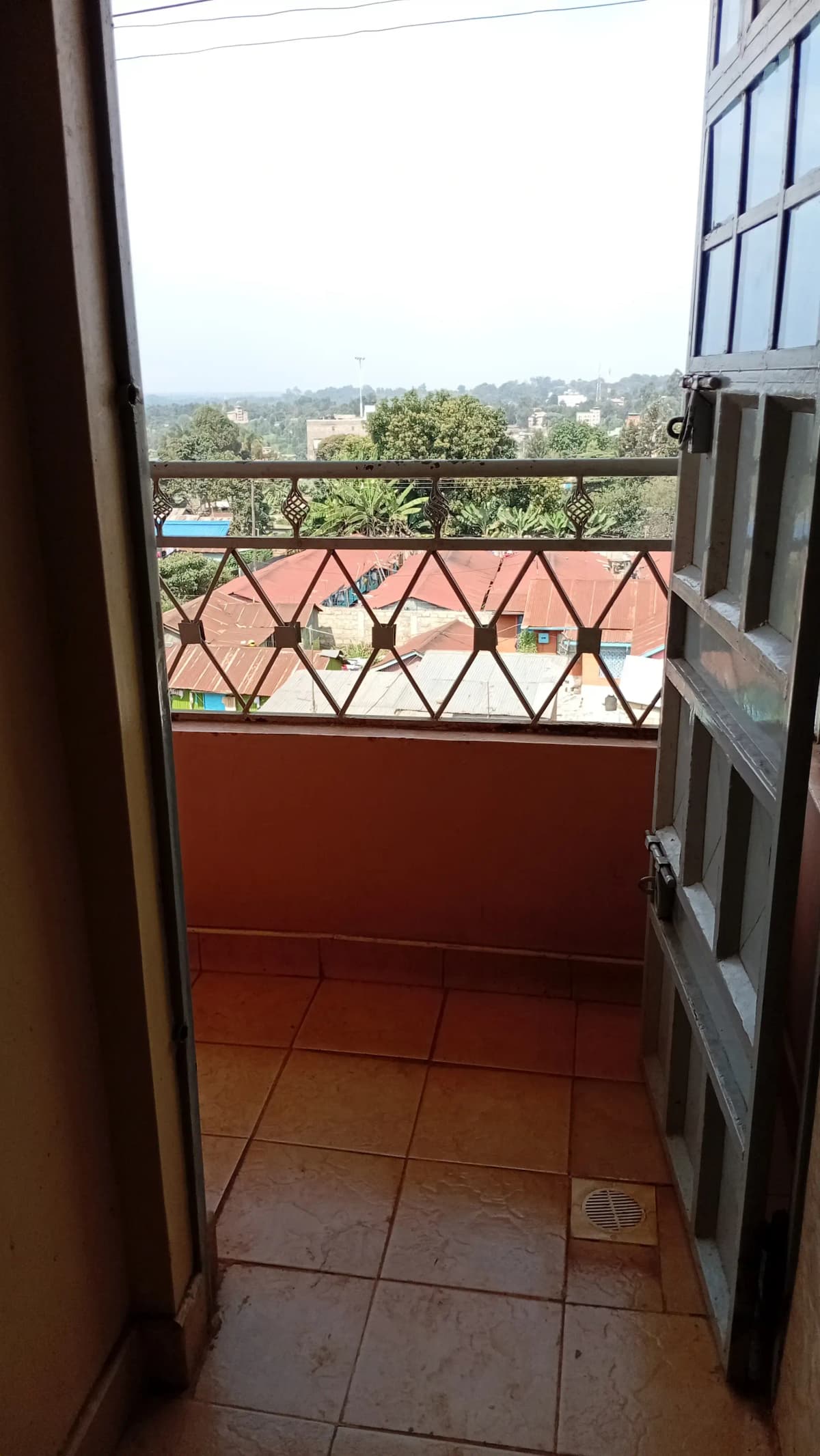 Terracotta-tiled balcony with city and landscape views