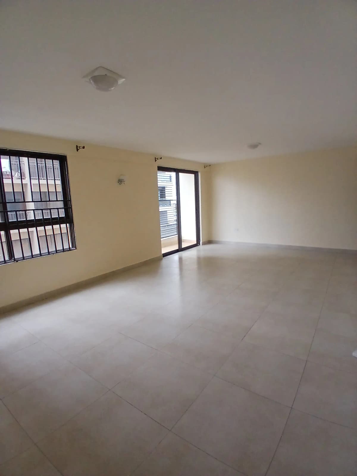 Spacious empty living room with polished concrete flooring