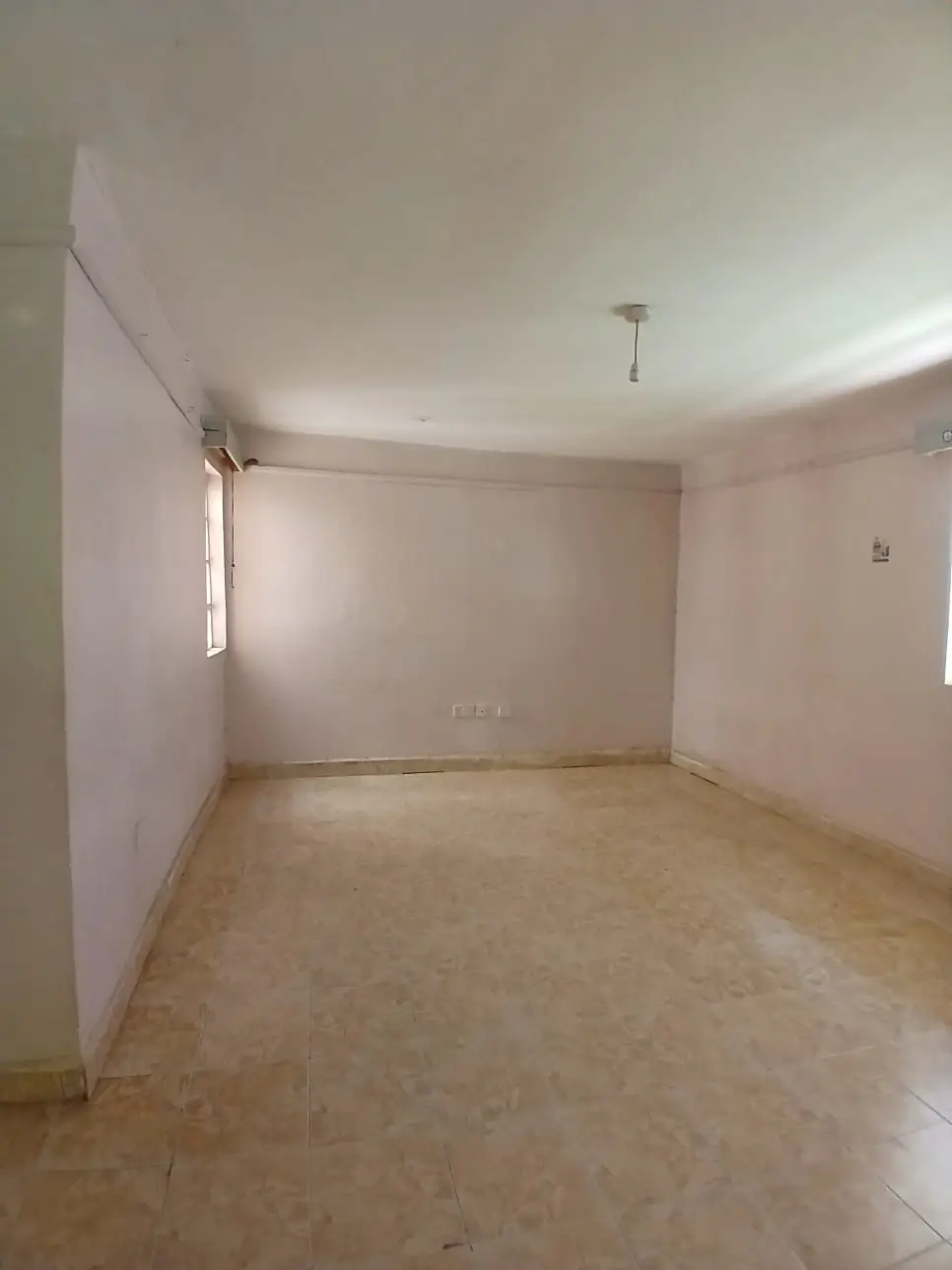 Spacious empty living room with natural light from window