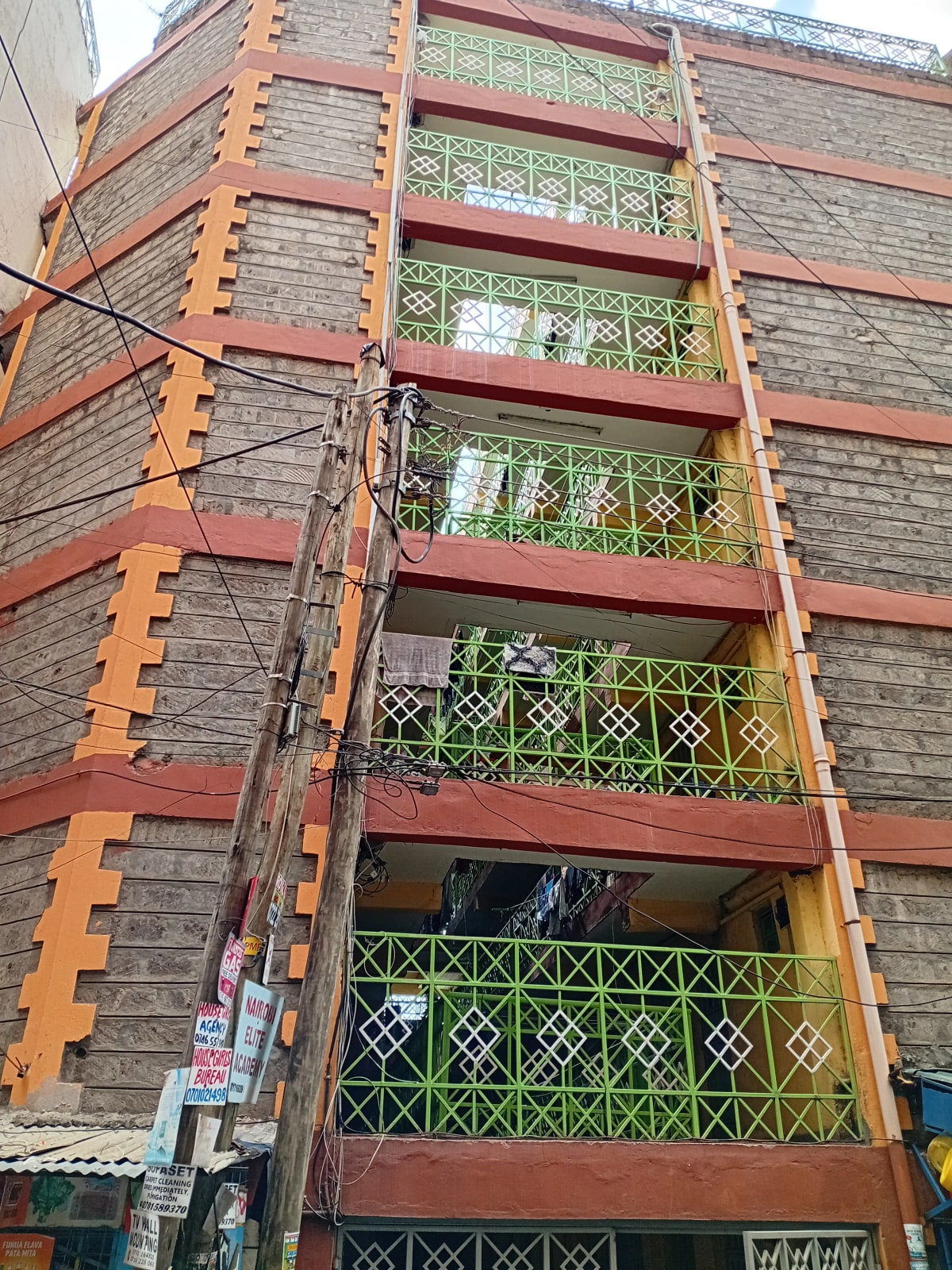 Multi-story apartment building facade with metal balconies