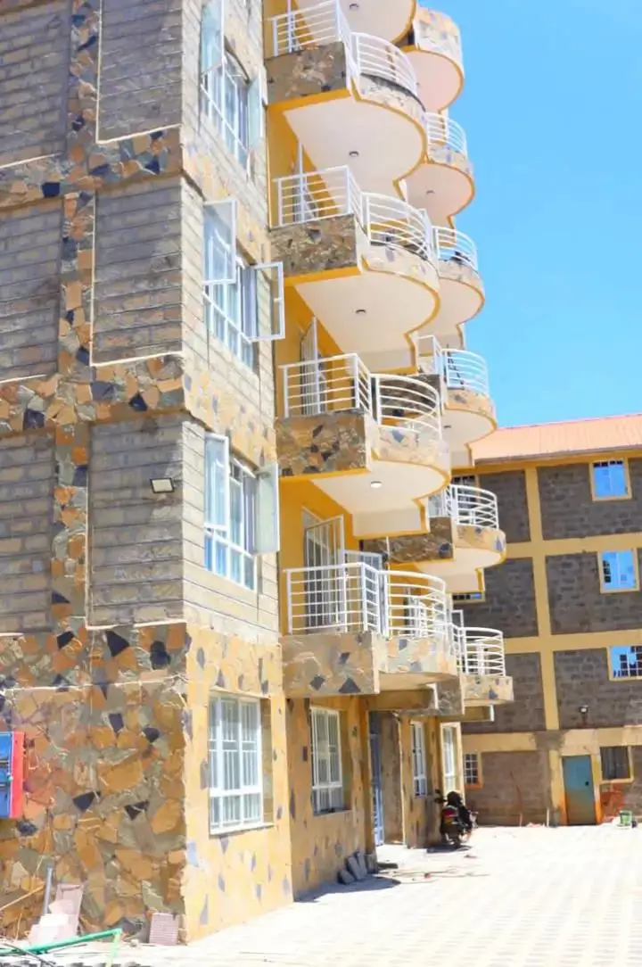 Multi-story residential building with stacked yellow balconies