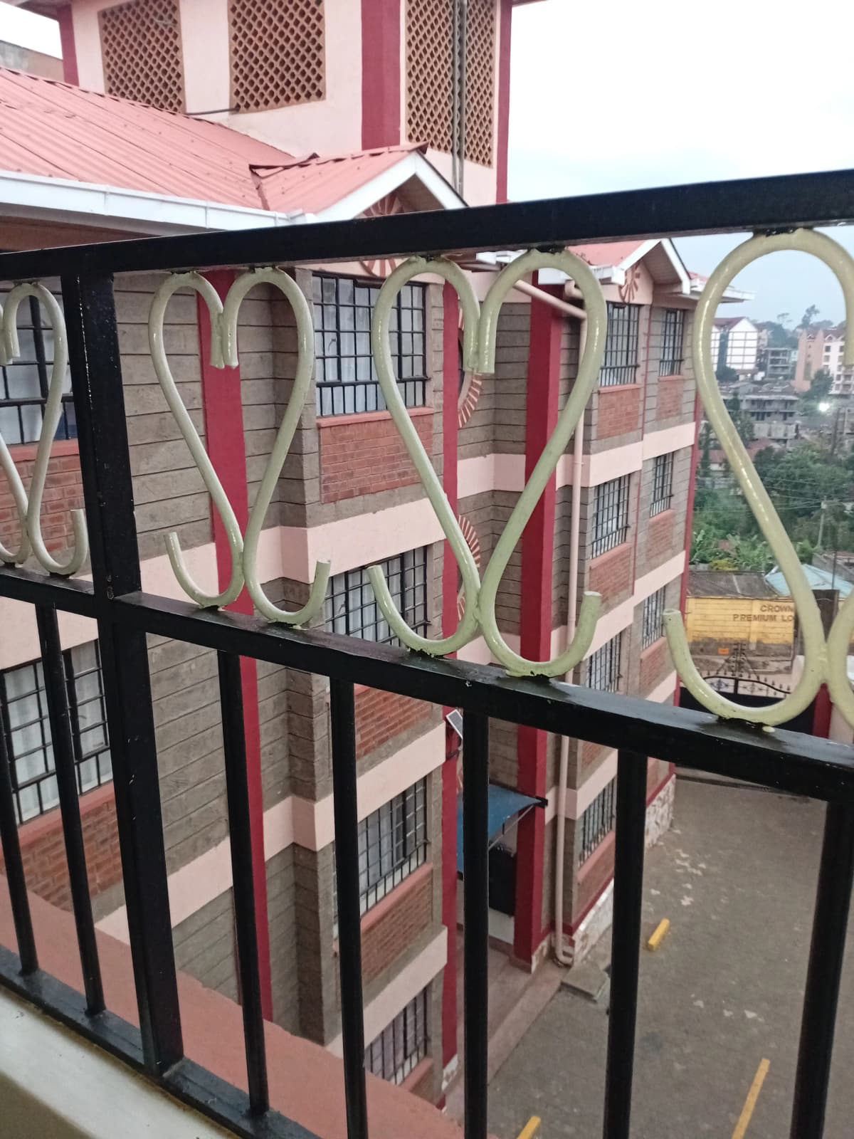Balcony with decorative railing overlooking residential neighborhood