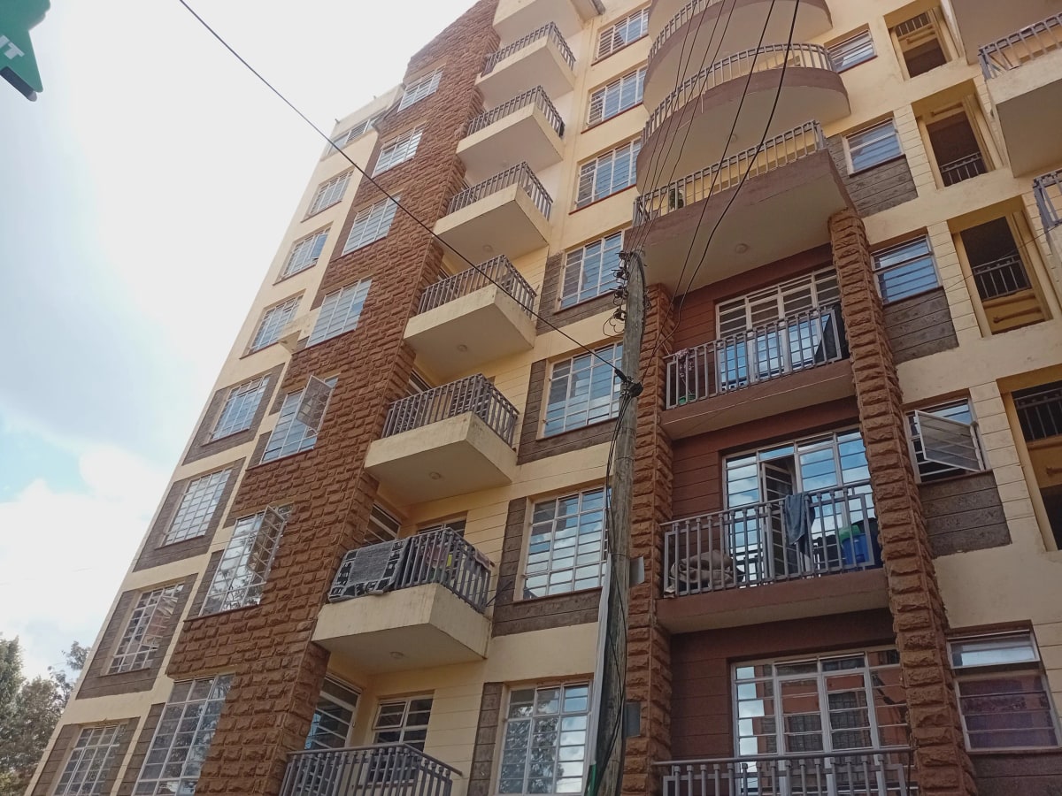 Multi-story residential building with brick and cream facade