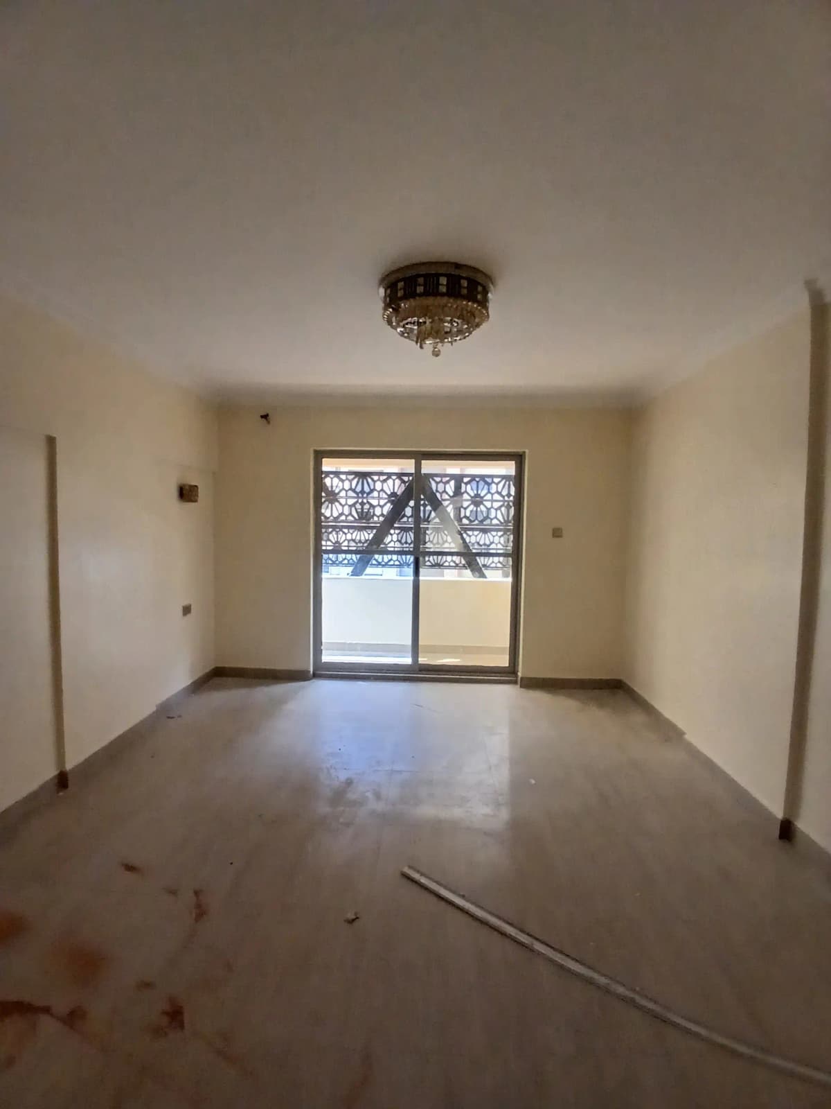 Empty living room with polished concrete floor and balcony access
