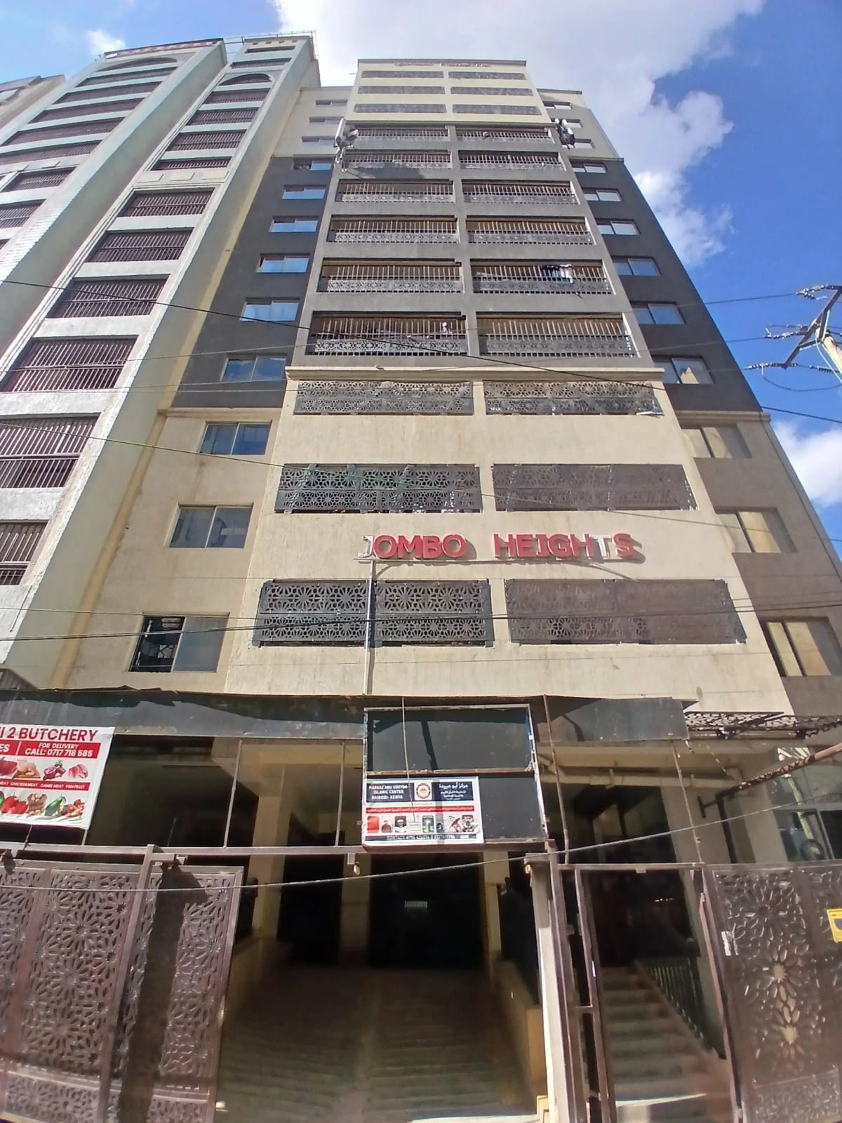 Multi-story residential building facade with ground-floor commercial space