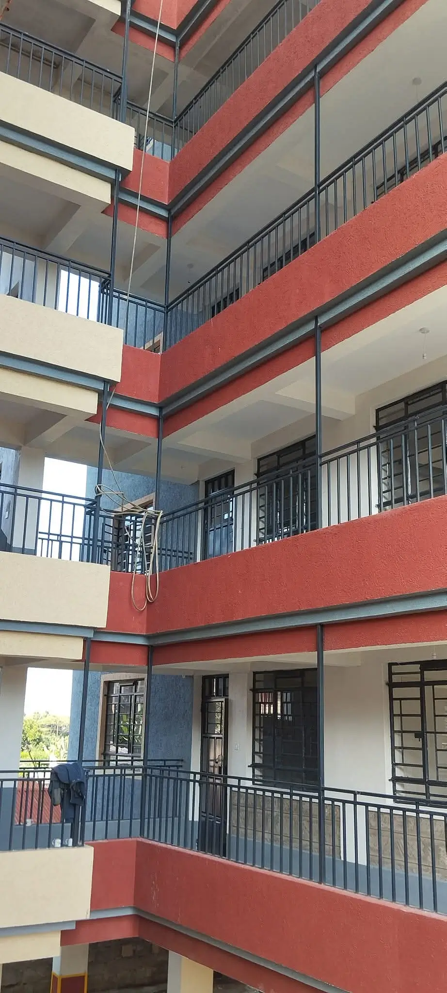Multi-story building atrium with tiered balconies and railings