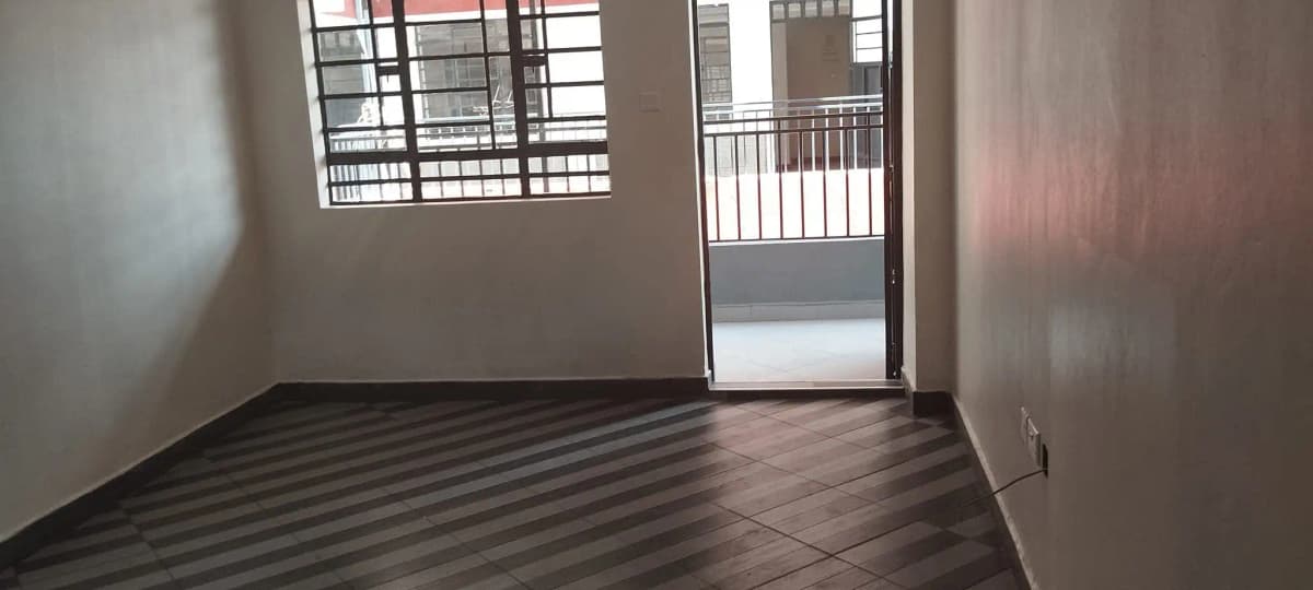 Striped tile balcony with metal railing and glass door