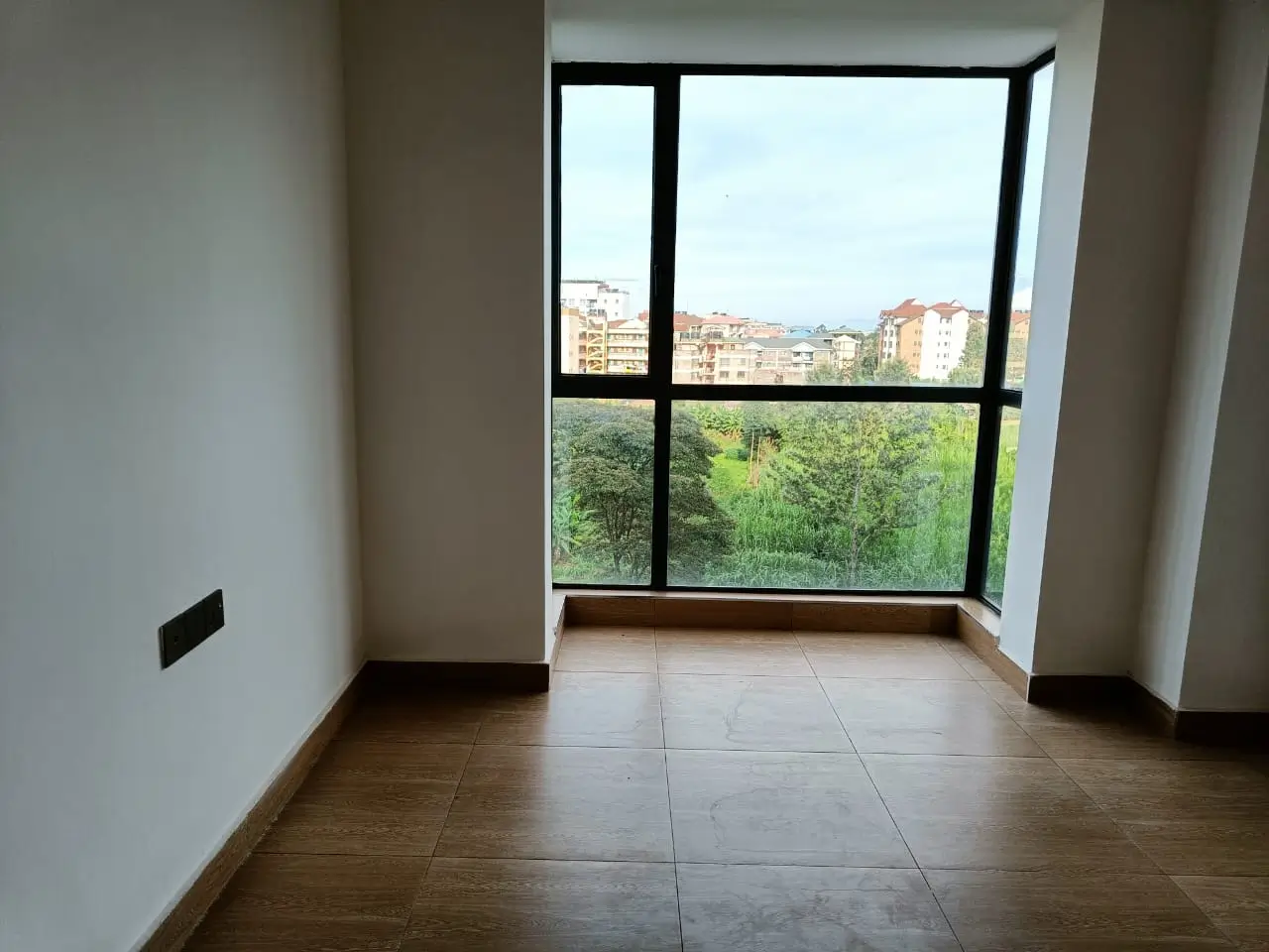 City and green space views from modern high-rise apartment