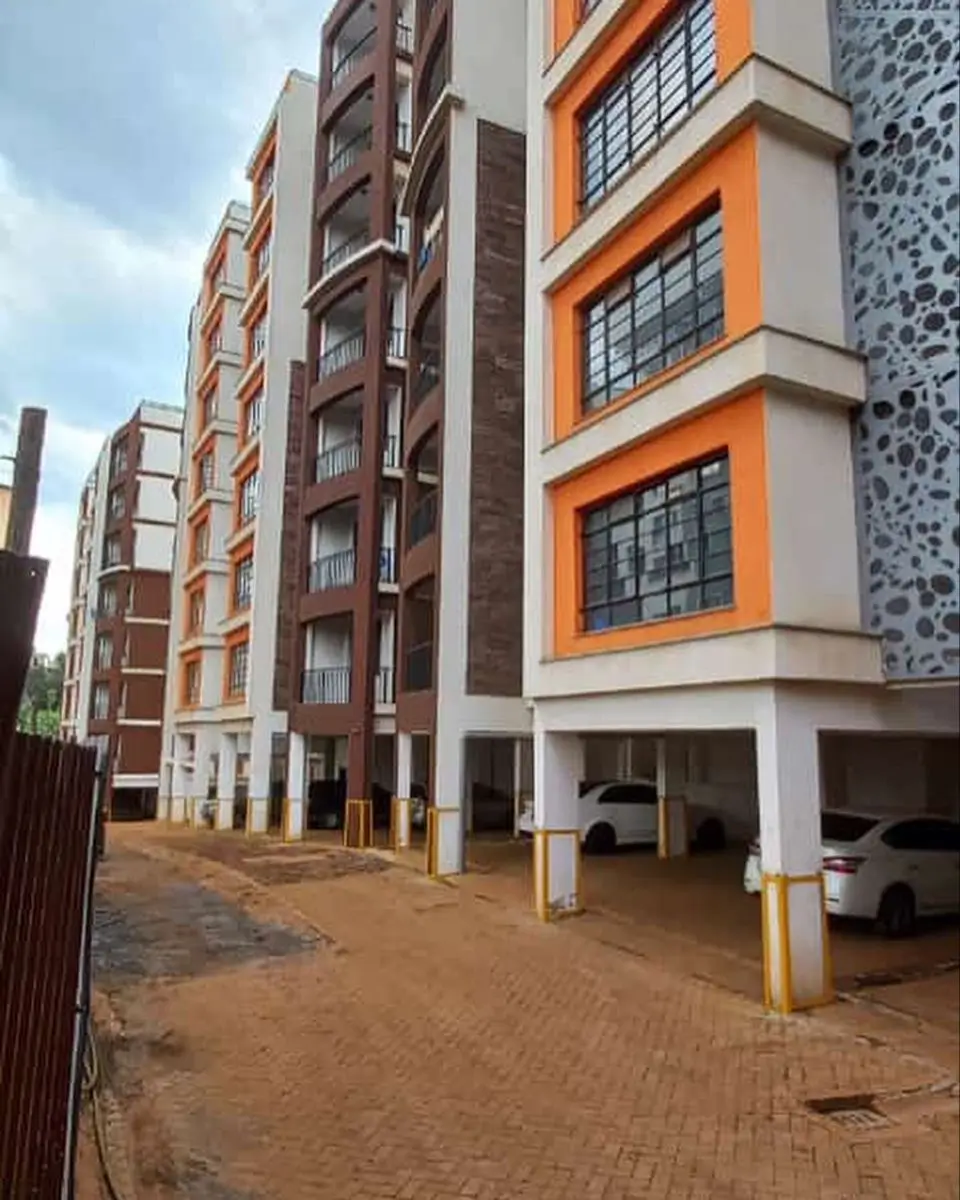 Ground-level parking area with residential building above