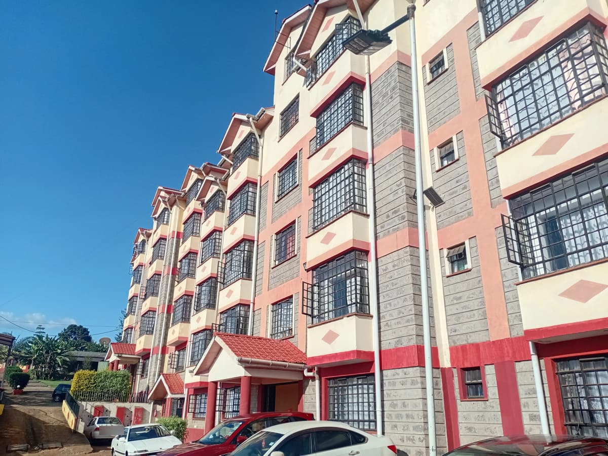 Multi-story residential building with red and cream facade