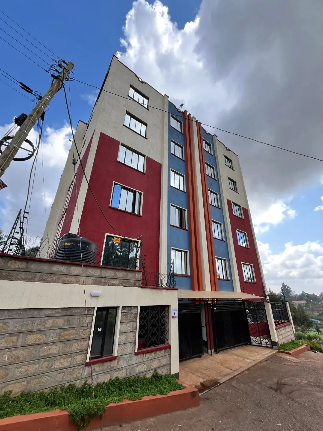 Modern residential apartment building with red and cream facade