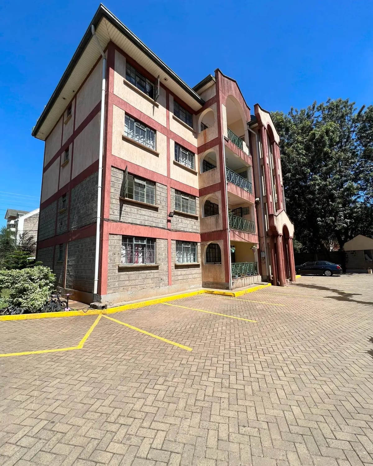 Multi-story residential building with pink and brown facade