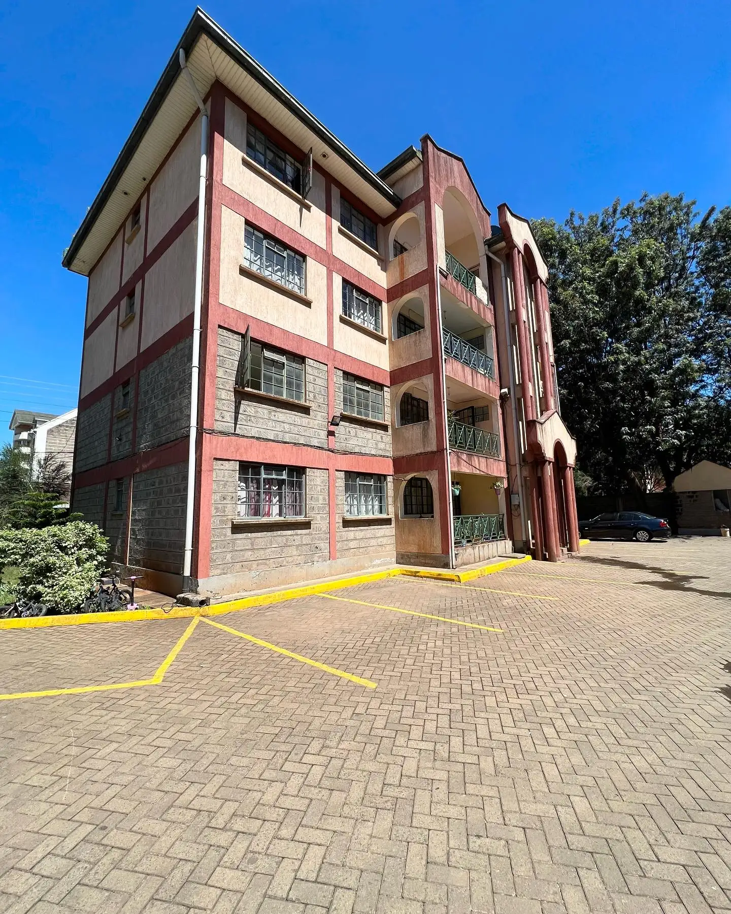 Multi-story residential building with pink and brown facade
