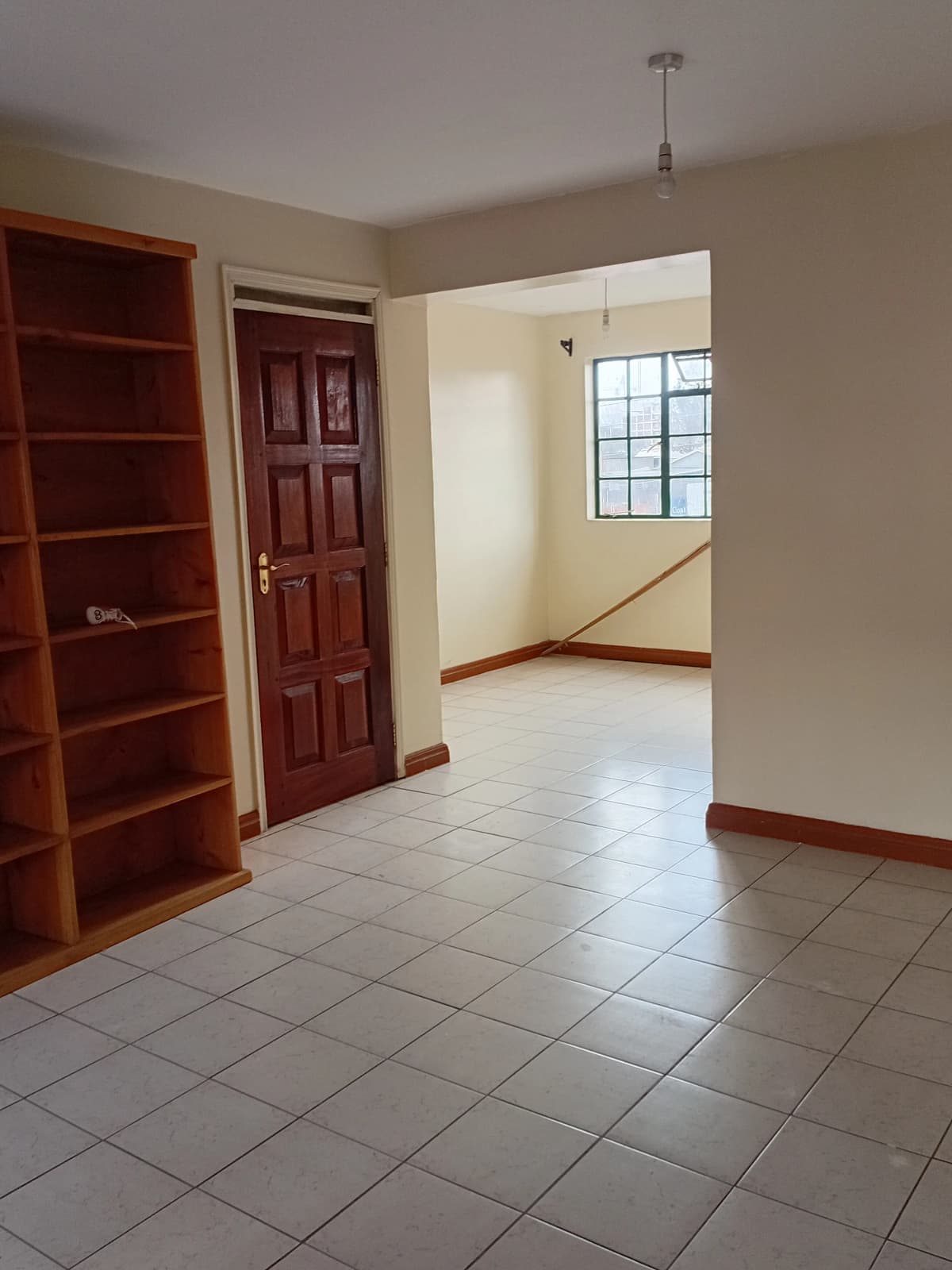 Bright corridor with tiled floor and wooden trim details