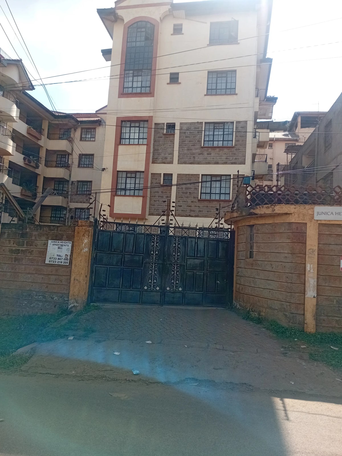 Multi-story residential building with gated compound entrance