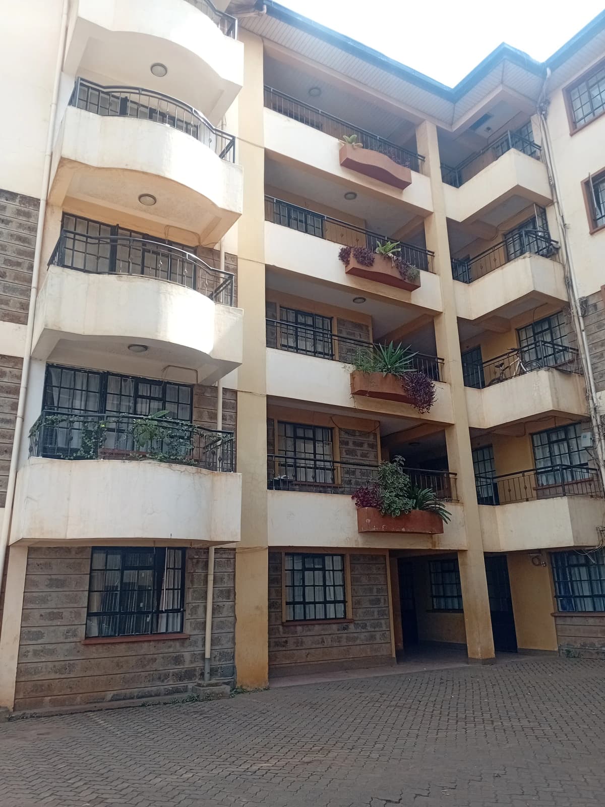 Multi-story residential building with balconies and brick facade