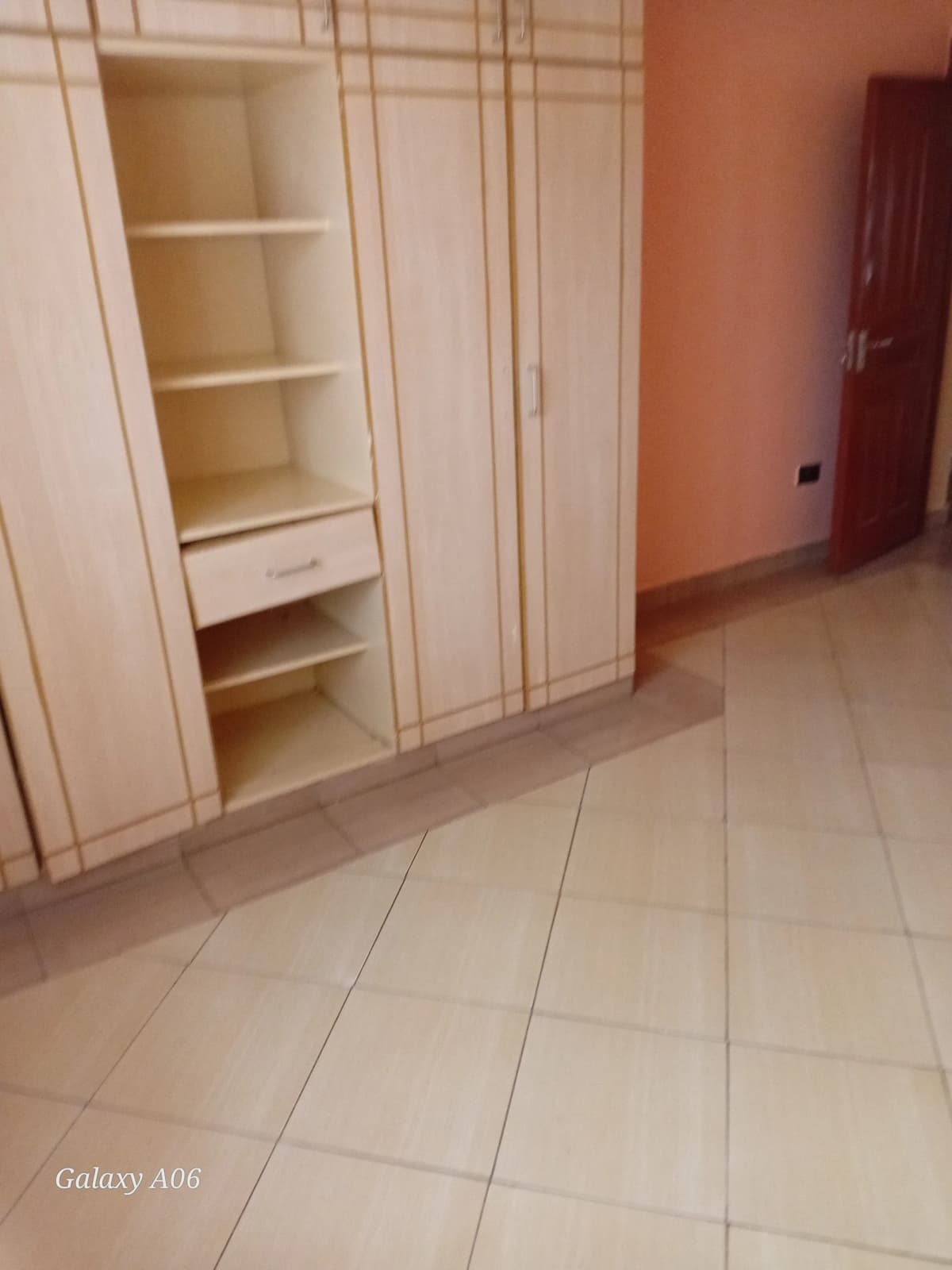 Bedroom with built-in wardrobes and tile flooring