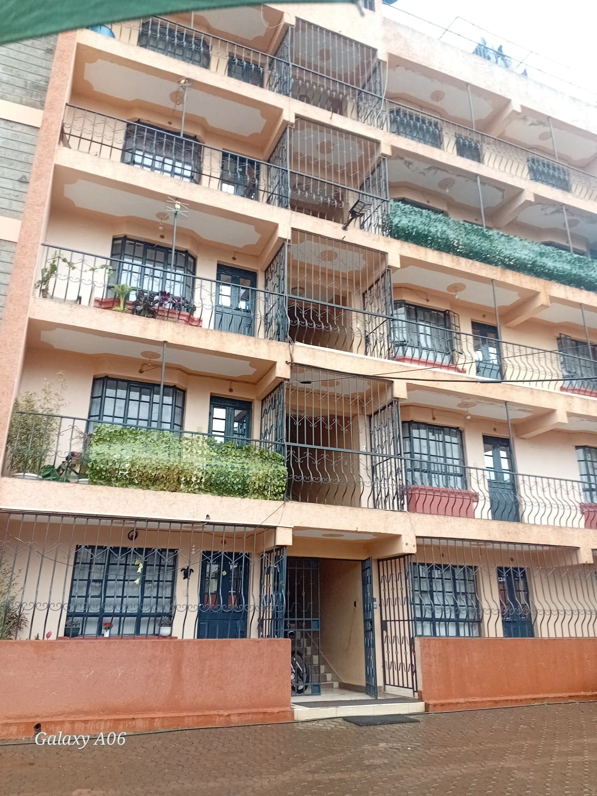 Multi-story residential building facade with balconies and metal railings