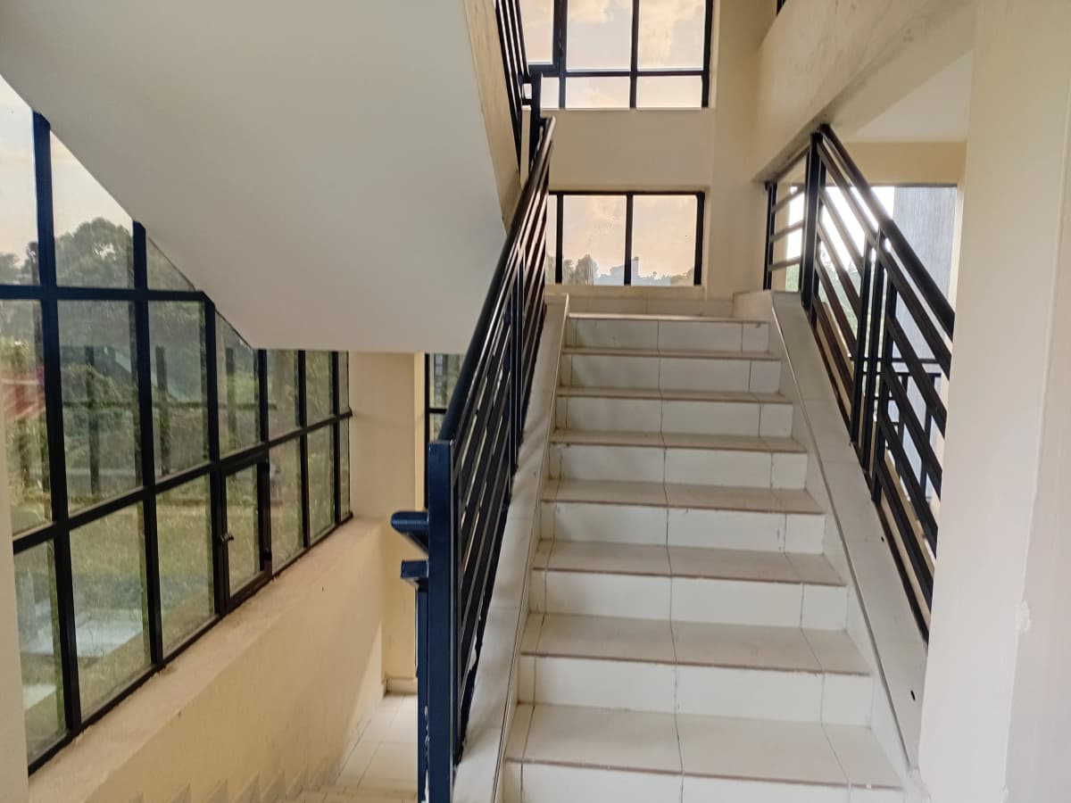 Multi-story stairwell with metal railings and natural light
