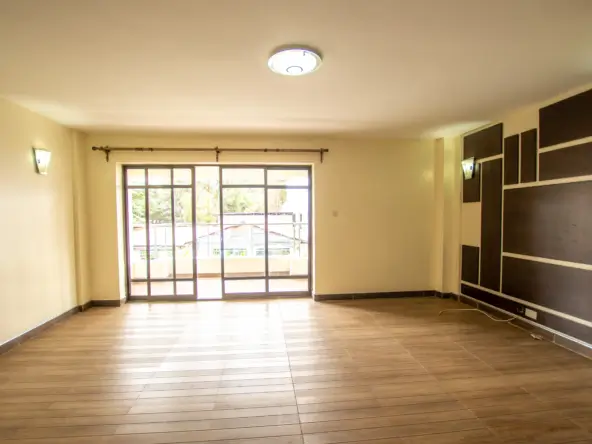 Spacious living room with wooden flooring and glass sliding doors