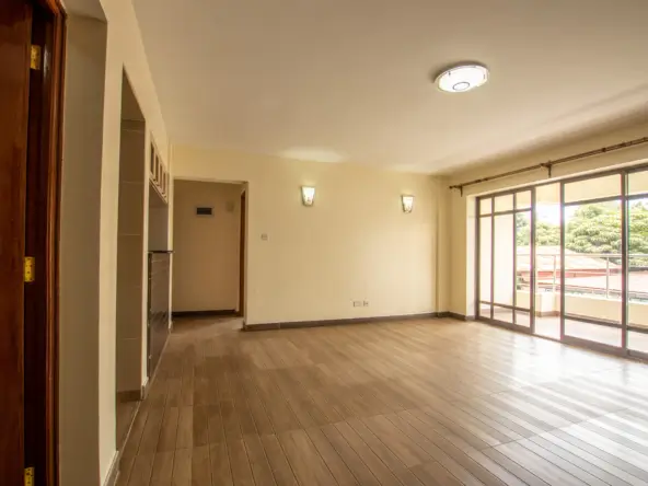 Spacious living room with wooden floors and glass doors