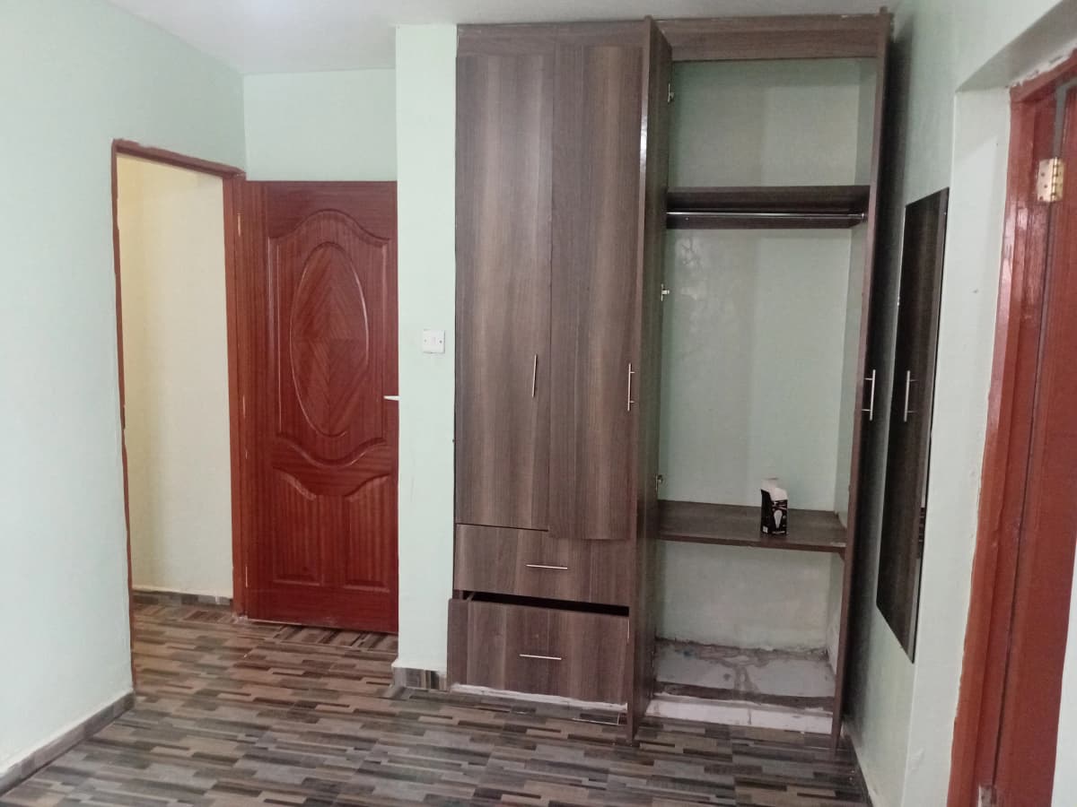 Unfurnished bedroom with built-in wardrobe and red doors