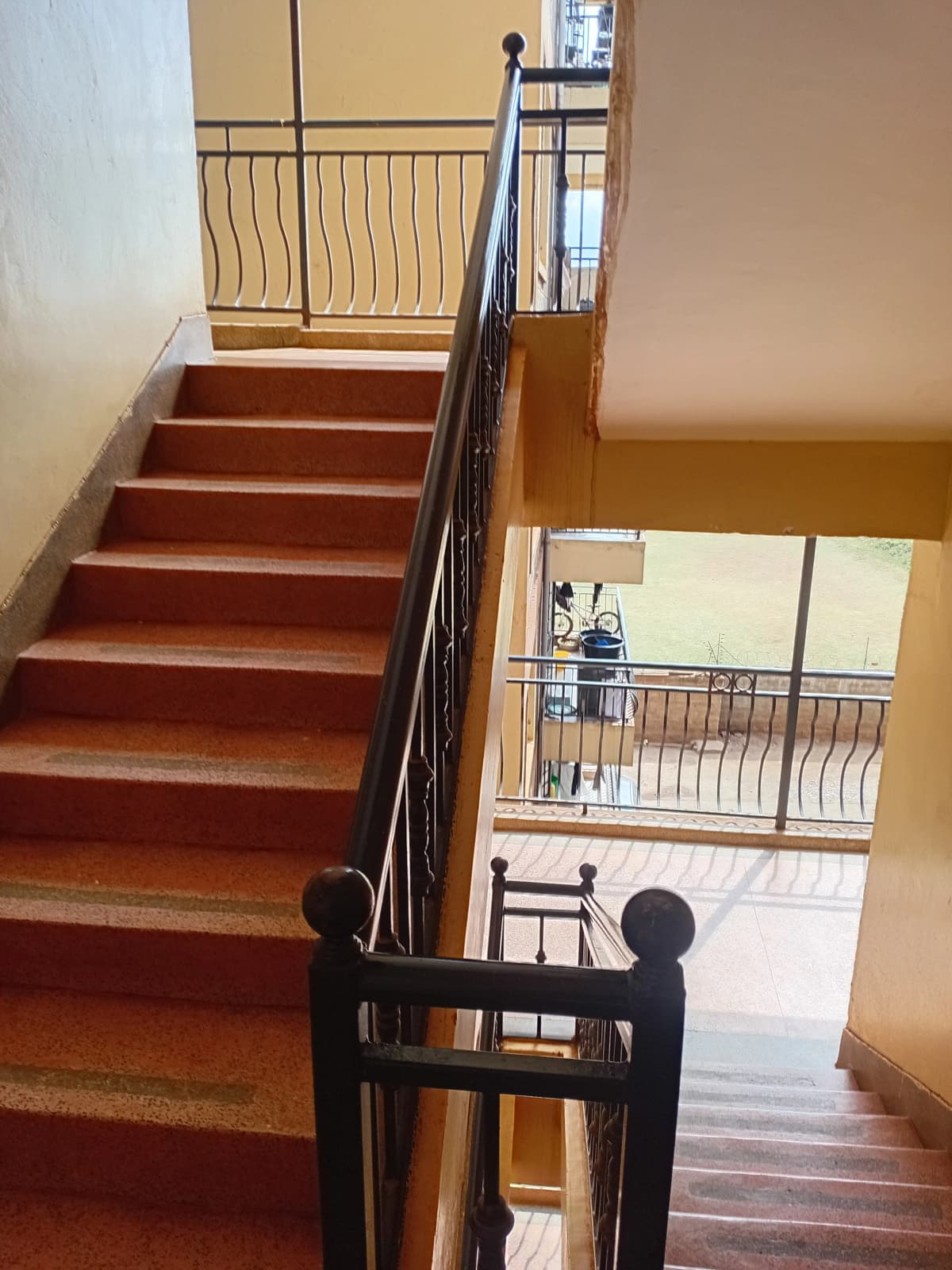 Internal staircase with wooden steps and metal railings