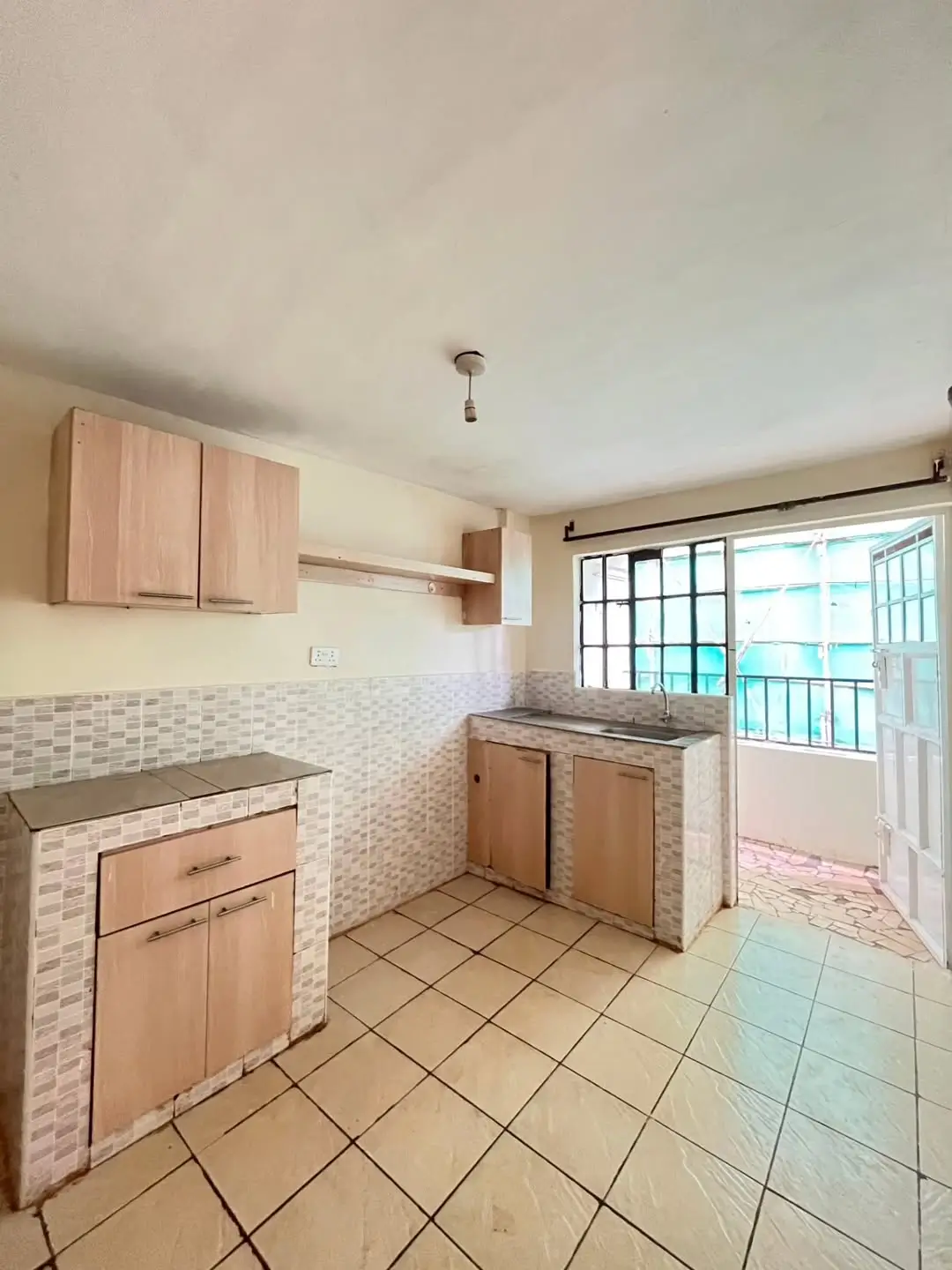 Spacious kitchen with tiled counters, wooden cabinets, ocean view