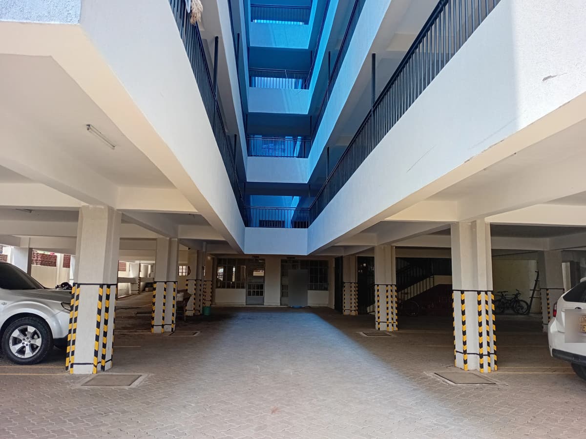 Underground parking garage with multiple bays and structural pillars