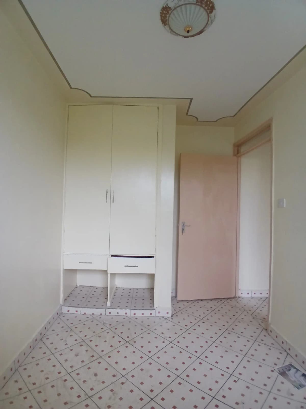 Compact bedroom with built-in wardrobe and storage cubbies