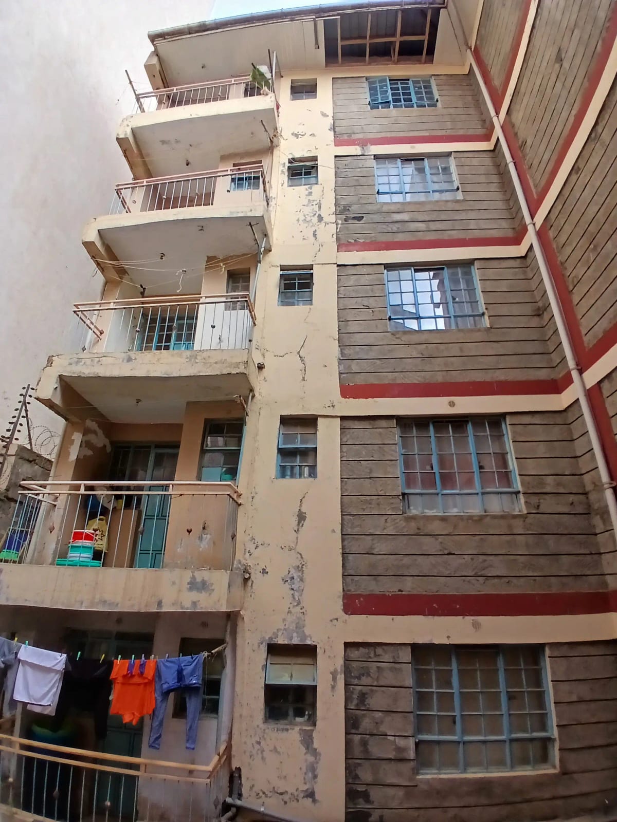 Multi-story residential building facade with balconies and windows