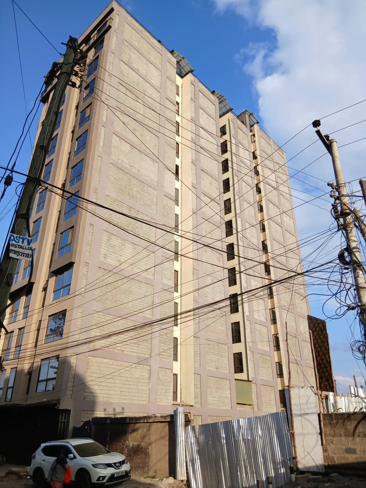Multi-story residential building facade with regular window pattern