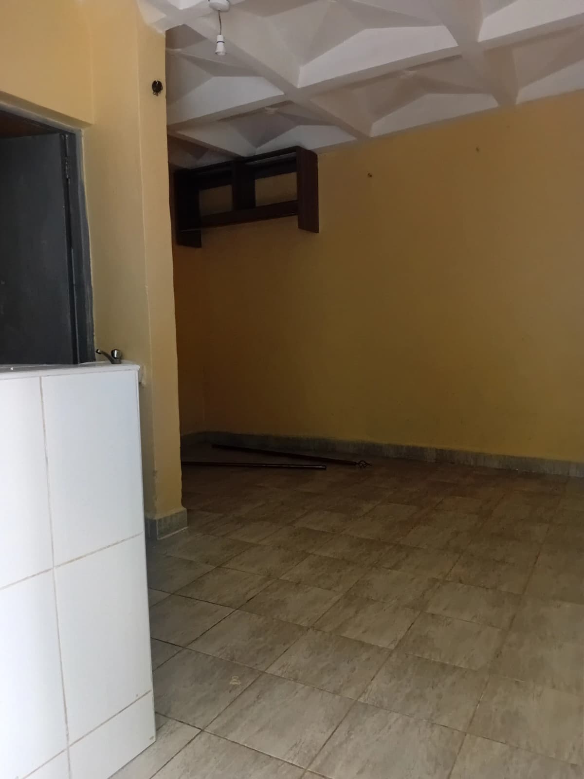 Empty living space with yellow walls and coffered ceiling